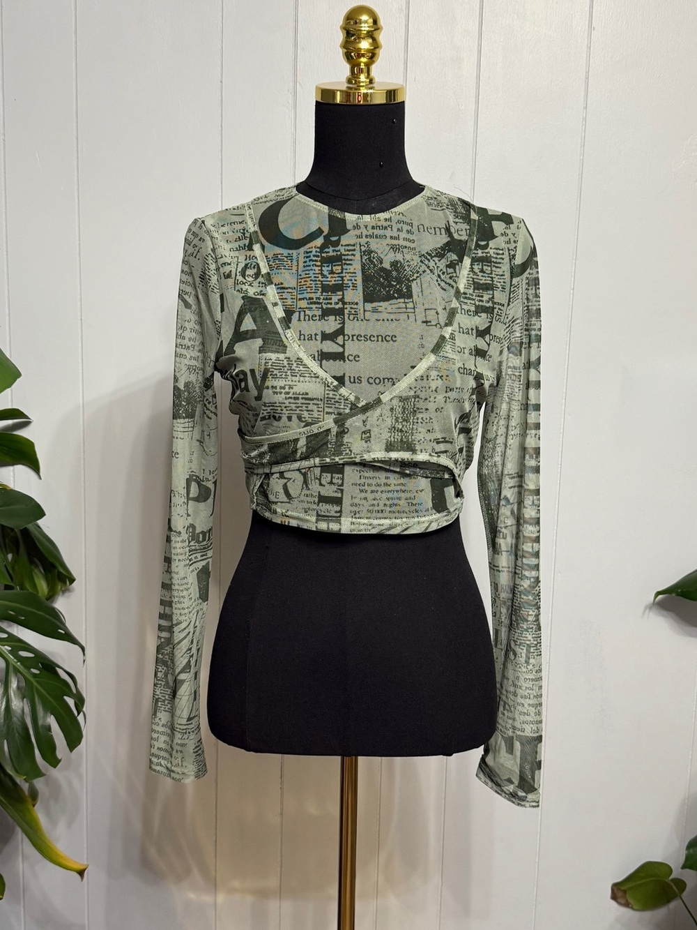 #19)  PrettyLittleThing Green Newspaper Print Long Sleeve Crop Top